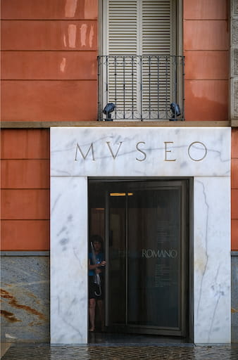 Bright white marble doorway contrasted against an orange wall