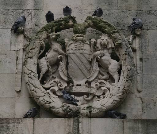 Pigeons sat atop a stone crest