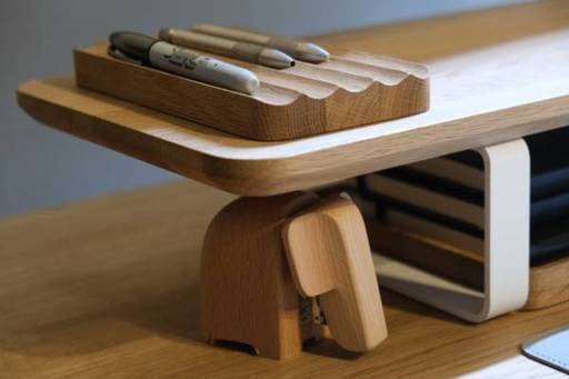 pen holder, stapler, notebooks on shelf